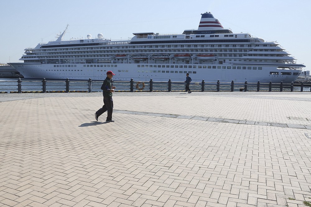A few people jog in an empty Minatomirai area amid an outbreak of the new coronavirus in Yokohama near Tokyo, Monday, April 6, 2020. The United Nations Secretary-General Antonio Guterres on Tuesday, Aug. 25, 2020, said the global tourism industry has been devastated by the coronavirus pandemic, with $320 billion lost in exports in the first five months of the year and more than 120 million jobs at risk. (AP Photo/Koji Sasahara)