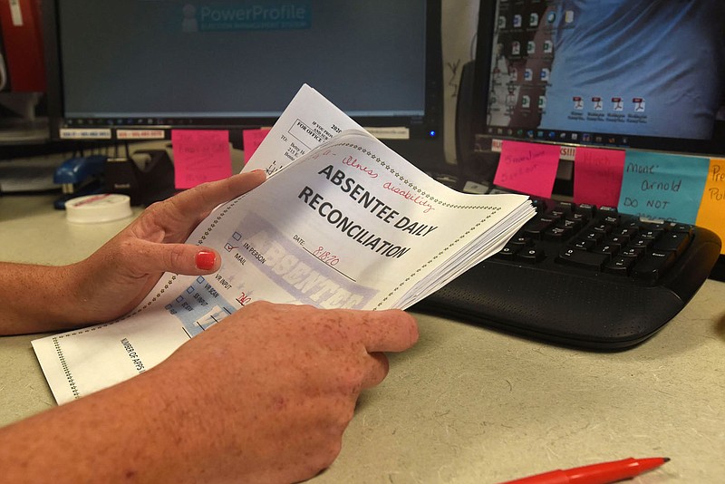 Dana Caler processes absentee ballot requests on Tuesday Aug. 18 at the Benton County clerk's office in downtown Bentonville.
(NWA Democrat-Gazette/Flip Putthoff)