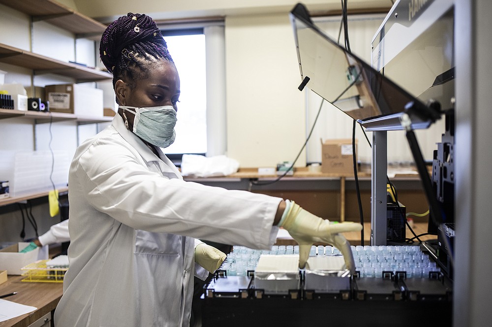 A technician loads saliva tests at the Waksman Institute of Microbiology. MUST CREDIT: photo for The Washington Post by Bryan Anselm.