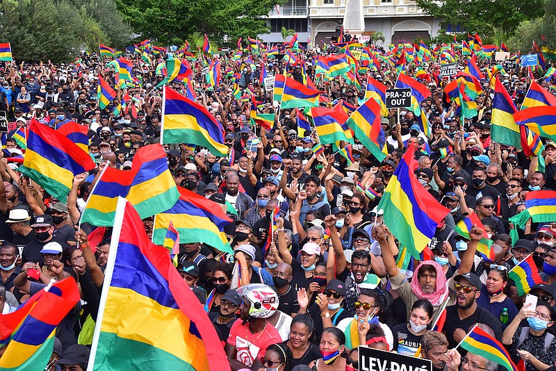 Tens of thousands of people protest in Port Louis, Mauritius, Saturday Aug. 29, 2020, over the government's slow response to an oil spill from a grounded Japanese ship and the alarming discovery of dozens of dead dolphins . (Beekash Roopun/L'express Maurice via AP)