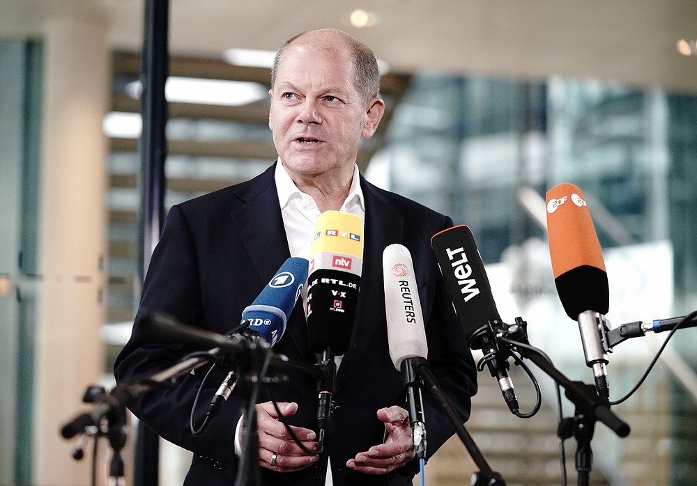 Olaf Scholz, Federal Minister of Finance and top candidate of social democrats, speaks before the SPD headquarters in a statement on the Corona demonstrations in Berlin, Germany, Sunday, Aug. 30, 2020. Over the weekend, several tens of thousands of people demonstrated in the capital against the corona measures of the federal government. This also led to clashes with the police. (Kay Nietfeld/dpa via AP)