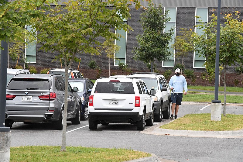 Zachary Lee walks to his car Wednesday Sept. 2, 2020 in lot 56D at the University of Arkansas in Fayetteville. Lee, a junior at the university, pays more than $100 for his parking space that is a 10-15 minute walk to class. (NWA Democrat-Gazette/J.T.WAMPLER)
