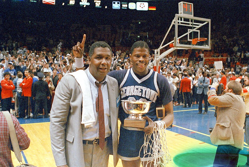 FILE - In this March 9, 1985, file photo, Georgetown NCAA college basketball head coach John Thompson poses with player Patrick Ewing after Georgetown defeated Houston in the NCAA college basketball championship game, in Seattle. John Thompson, the imposing Hall of Famer who turned Georgetown into a “Hoya Paranoia” powerhouse and became the first Black coach to lead a team to the NCAA men’s basketball championship, has died. He was 78 His death was announced in a family statement Monday., Aug. 31, 2020. No details were disclosed.(AP Photo/File) story.lead_photo.caption