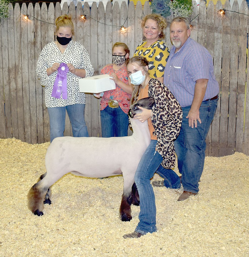 STAFF PHOTO/Abbi Kelly, of Hogeye 4-H/Har-Ber FFA, showed at the Washington County Fair getting $900 for her Grand Champion Commercial Ewe during the 2020 Junior Livestock Premium Auction Aug. 27. Brian Dobbs was the buyer.
