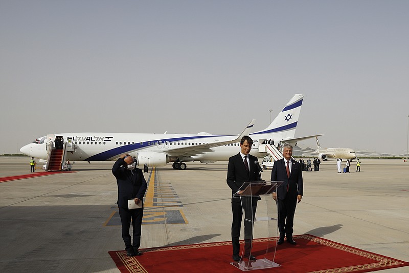 U.S. President Donald Trump's senior adviser Jared Kushner, center, speaks as Israeli National Security Advisor Meir Ben-Shabbat, left, and U.S. National Security Advisor Robert O'Brien stand by after an El Al plane from Israel landed in Abu Dhabi, United Arab Emirates, Monday, Aug. 31, 2020. The El Al plane completed the first-ever direct commercial passenger flight to the United Arab Emirates. The Israeli flag carrier’s flight Monday marks the implementation of the historic U.S.-brokered deal to normalize relations between the Israel and the UAE. (Nir Elias/Pool Photo via AP)