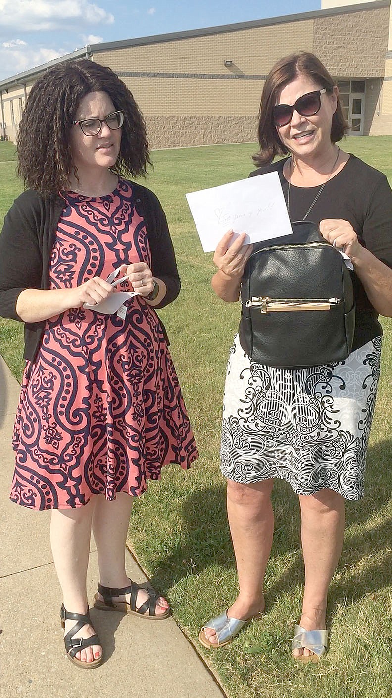 COURTESY PHOTO
State Rep. Charlene Fite, right, presents a $1,000 scholarship to Kendra Thompson of Prairie Grove on behalf of Women's Own Worth, an organization that helps survivors of domestic violence and childhood trauma. Thompson submitted an essay sharing her story of overcoming childhood trauma in hopes of inspiring others that a bright future is accessible.