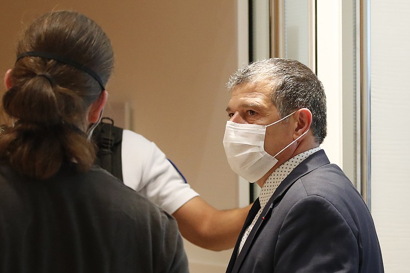 Michel Catalano, owner of the printing house stormed by gunmen Cherif and Said Kouachi, arrives at the Paris courthouse for the opening of the 2015 attacks trial, Wednesday, Sept. 2, 2020 in Paris. Thirteen men and a woman go on trial Wednesday over the 2015 attacks against a satirical newspaper and a kosher supermarket in Paris that marked the beginning of a wave of violence by the Islamic State group in Europe. Seventeen people and all three gunmen died during the three days of attacks in January 2015. (AP Photo/Francois Mori)