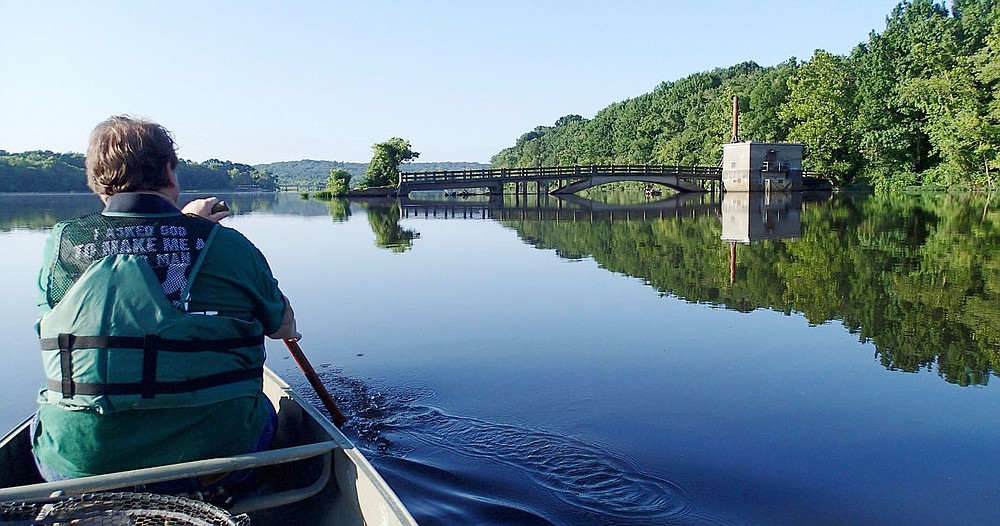 Alan Bland of Rogers paddles Aug. 3 2020 near the old bridge that spanned the White River before Lake Sequoyah was built.
(NWA Democrat-Gazette/Flip Putthoff)