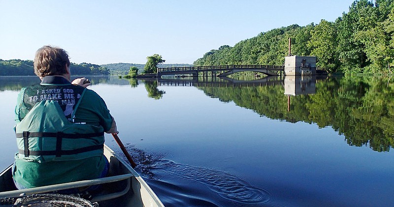 Alan Bland of Rogers paddles Aug. 3 2020 near the old bridge that spanned the White River before Lake Sequoyah was built. 
(NWA Democrat-Gazette/Flip Putthoff)