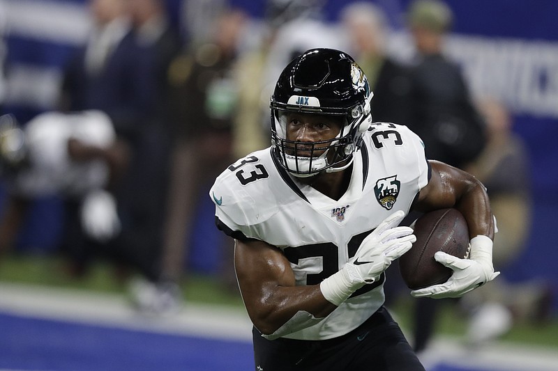 FILE - Jacksonville Jaguars running back Devine Ozigbo (33) runs before an NFL football game against the Indianapolis Colts, Sunday, Nov. 17, 2019, in Indianapolis. As stunning as Leonard Fournette’s departure was from Jacksonville, his replacement might be equally surprising. Jacksonville expects to split the bulk of the work between second-year pro Devine Ozigbo and undrafted rookie James Robinson.(AP Photo/Michael Conroy, File)