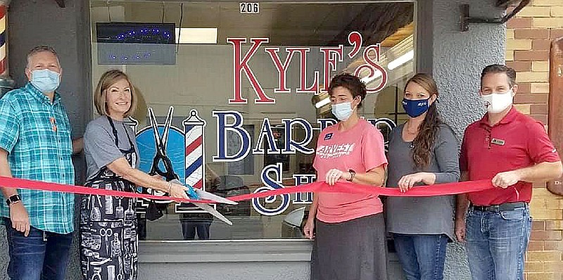 Submitted/JANIE PARKS, GENTRY CHAMBER OF COMMERCE
Kyle's Barber Shop opened Wednesday Aug. 5, in the old Sullivan's Barber Shop building, at 206 E. Main Street in Gentry. Barber Kelle Kyle has 31 years experience in the business and comes from Flippin. Her hours are 9 to 5 Wednesday, Thursday and Friday. Appointments are not necessary and walk-ins are welcome. A ribbon cutting was held Sept. 2, with Kelle Watson Kyle and her husband Terry cutting the ribbon. Also in attendance were Lisa Roberts and Jessica Ward from Arvest Bank and Gentry Mayor Kevin Johnston. For more information or to make an appointment, call 870-405-6232.