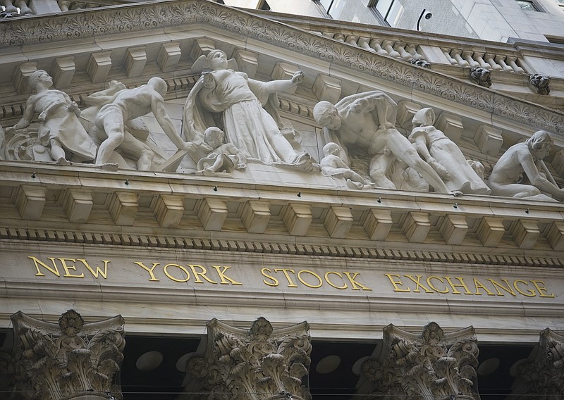 FILE - Marble sculptures occupy the pediment above the New York Stock Exchange signage, Tuesday Aug. 25, 2020, in New York.  Stocks are falling again on Wall Street Friday, Sept. 4,  a day after a big slump in technology companies pulled the market to its biggest drop since June.  (AP Photo/Bebeto Matthews, File)