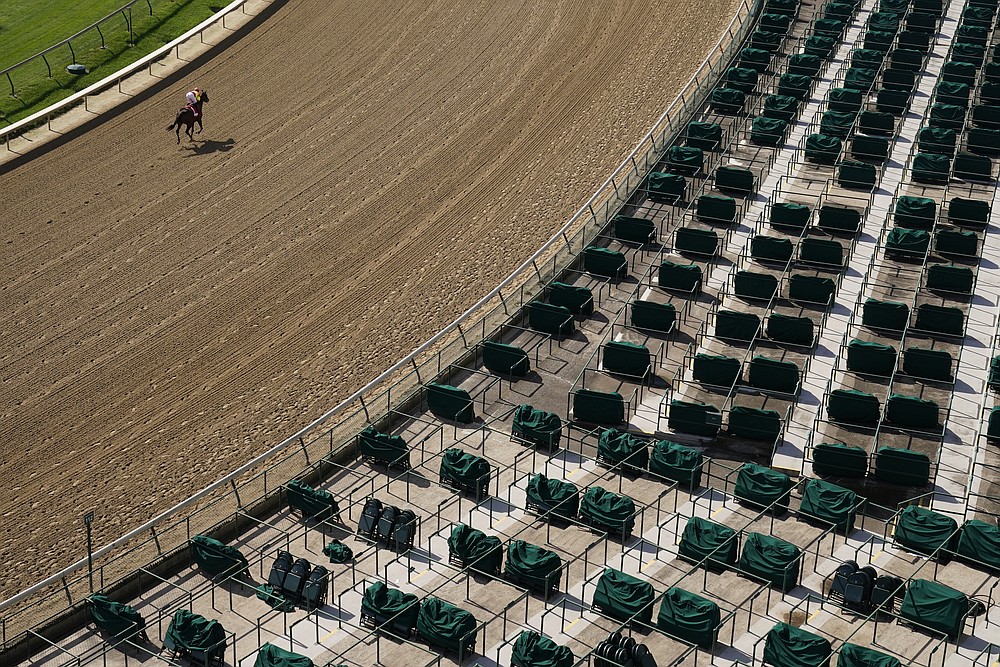 A horse heads to the starting gate for the first race of the day before the 146th running of the Kentucky Oaks at Churchill Downs, Friday, Sept. 4, 2020, in Louisville, Ky. (AP Photo/Charlie Riedel)