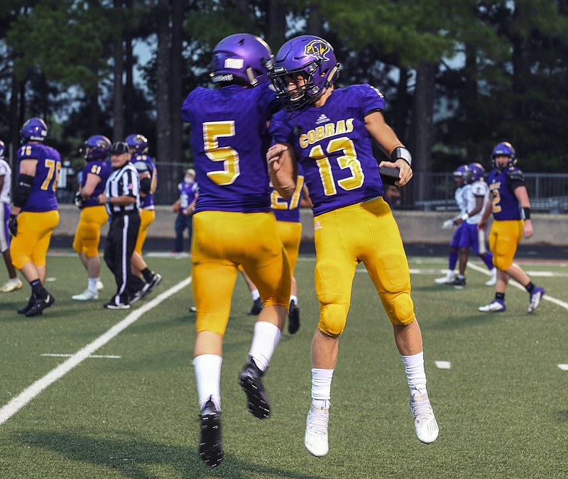 Fountain Lake junior Caleb Lacy (5) and senior Jack Wurz (13) celebrate after Lacy scores a touchdown in Friday's 54-18 win over England at Allen Tillery Field. - Photo by Grace Brown of The Sentinel-Record