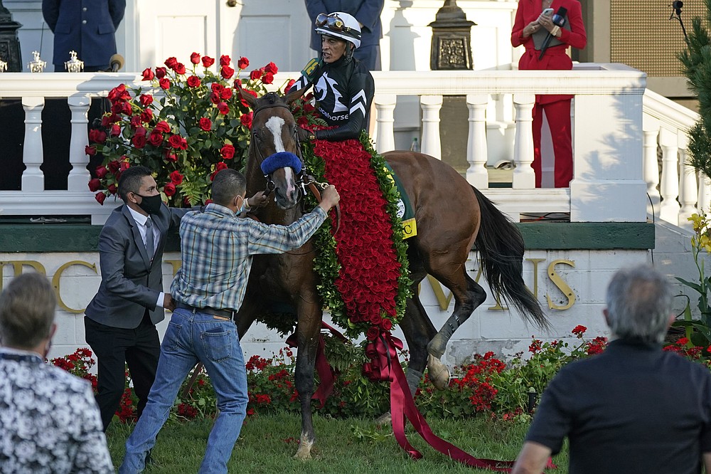 Jockey John Velazquez attempts to control Authentic in the winners' circle after winning the 146th running of the Kentucky Derby at Churchill Downs, Saturday, Sept. 5, 2020, in Louisville, Ky. (AP Photo/Jeff Roberson)