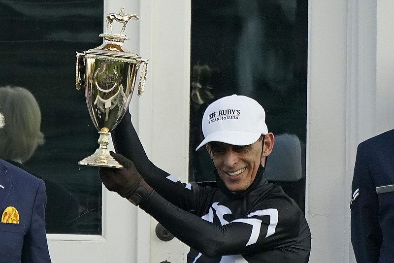 John Velazquez holds the trophy after riding Authentic to victory in the 146th running of the Kentucky Derby at Churchill Downs, Saturday, Sept. 5, 2020, in Louisville, Ky. (AP Photo/Jeff Roberson) story.lead_photo.caption