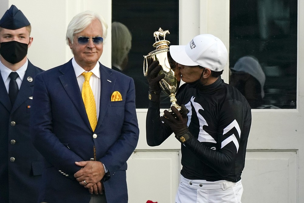 John Velazquez kisses the trophy after riding Authentic to victory in the 146th running of the Kentucky Derby at Churchill Downs, Saturday, Sept. 5, 2020, in Louisville, Ky. (AP Photo/Jeff Roberson)