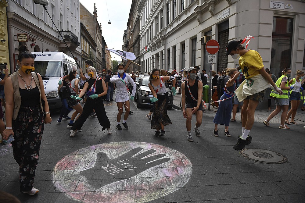 Students of the University of Theatre and Film Arts (SZFE) and their sympathizers form a human chain in protest against changes to the way the university is governed in Budapest, Hungary, Sunday, Sept. 6, 2020. (Marton Monus/MTI via AP)