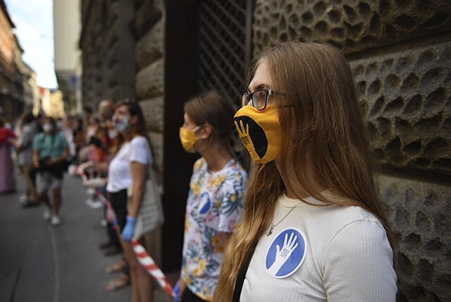 Students of the University of Theatre and Film Arts (SZFE) and their sympathizers form a human chain in protest against changes to the way the university is governed in Budapest, Hungary, Sunday, Sept. 6, 2020. (Marton Monus/MTI via AP)