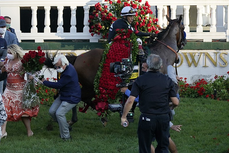 Trainer Bob Baffert is knocked to ground Saturday as Jockey John Velazquez tries to control Authentic in the winners' circle after winning the 146th running of the Kentucky Derby at Churchill Downs in Louisville, Ky. - Photo by Jeff Roberson of The Associated Press