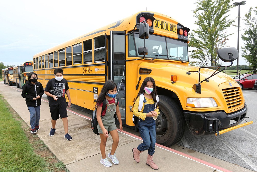 Students from Monitor Elementary School move to busses Tuesday, September 1, 2020, for a ride home in Springdale. Check out nwaonline.com/200903Daily/ and nwadg.com/photos for a photo gallery.
(NWA Democrat-Gazette/David Gottschalk)