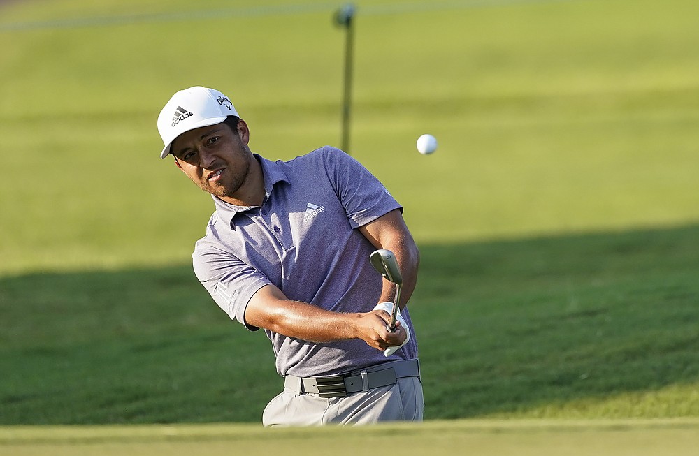 Xander Schauffele hits to the green on the 8th hole during the third round of the Tour Championship golf tournament at East Lake Golf Club in Atlanta, Sunday, Sept. 6, 2020. (AP Photo/John Bazemore)