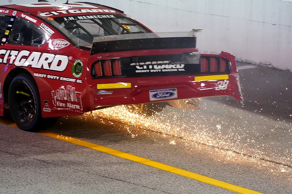 John Hunter (38) sparks up during a NASCAR Cup Series auto race Sunday, Sept. 6, 2020, in Darlington, S.C. (AP Photo/Chris Carlson)