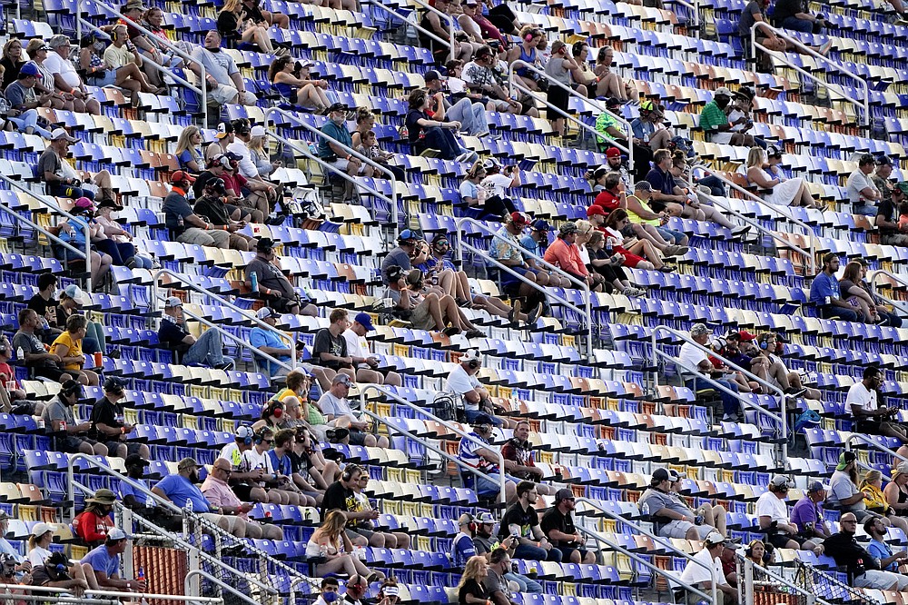 Fans watch the race during a NASCAR Cup Series auto race Sunday, Sept. 6, 2020, in Darlington, S.C. (AP Photo/Chris Carlson)