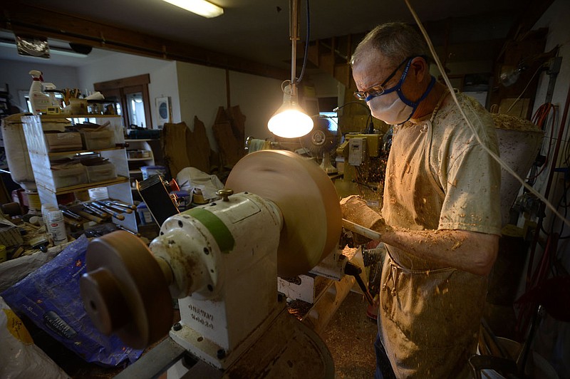 Woodworker Greg Thomas begins the process of turning a bowl from a piece of cherry Tuesday, Aug. 18, 2020, while working in his workshop at his home near Elkins. Visit nwaonline.com/200819Daily/ for today's photo gallery.
(NWA Democrat-Gazette/Andy Shupe) story.lead_photo.caption