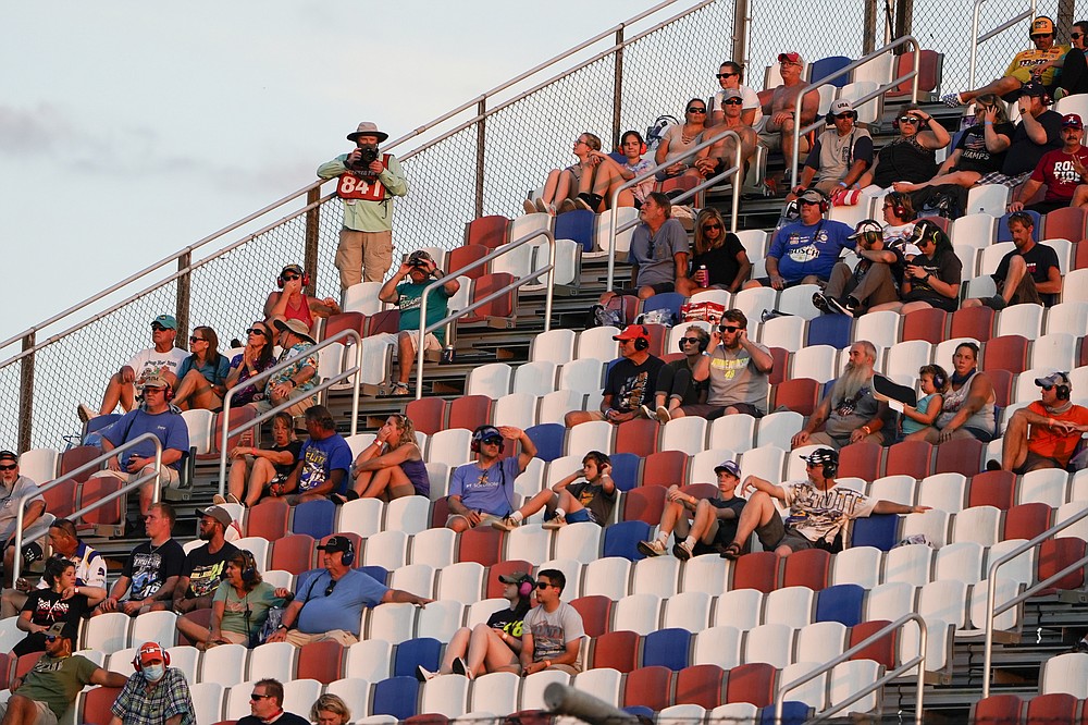 Fans watch the race during a NASCAR Cup Series auto race Sunday, Sept. 6, 2020, in Darlington, S.C. (AP Photo/Chris Carlson)