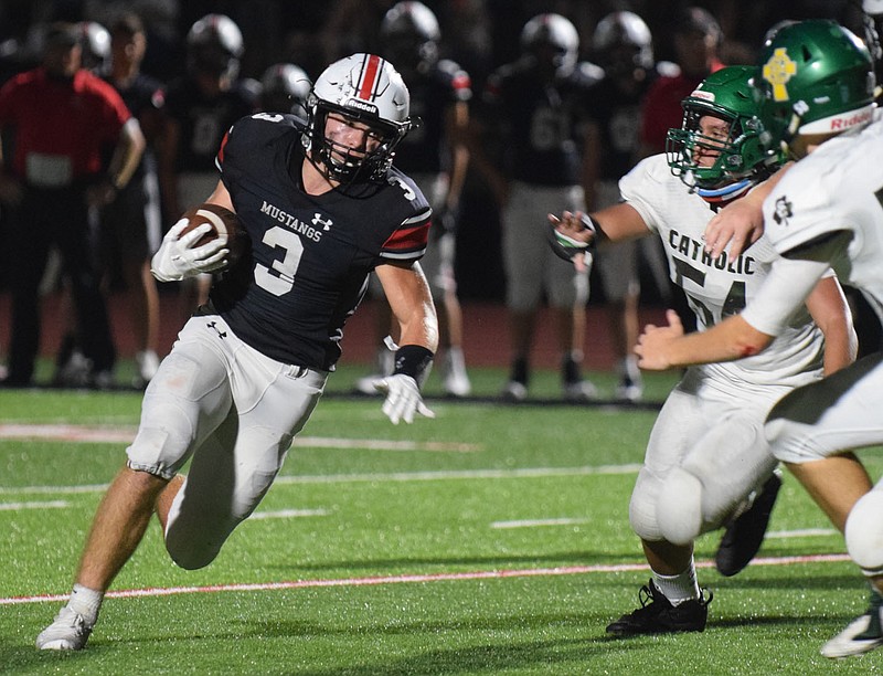 RICK PECK/SPECIAL TO MCDONALD COUNTY PRESS
McDonald County's Bailey Lewis runs for a big gain as Springfield Catholic's Blake Southern and Chase Haynes (54) prepare to make a tackle. Lewis finished with 241 yards on 24 carries in the Mustangs' 35-19 win on Sept. 4 at MCHS.