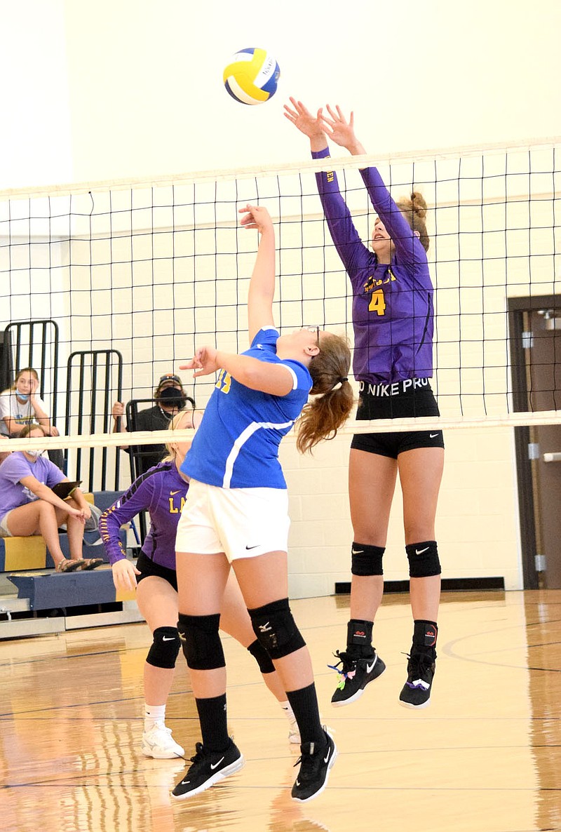 Westside Eagle Observer/MIKE ECKELS

Bell Bell (Decatur 14) taps the ball back over the net past a Lady Golden Arrow player and eventually into the arms of a waiting Lavaca player (behind Bell) during the first quarter of the Decatur-Lavaca volleyball match in Decatur Sept, 8.