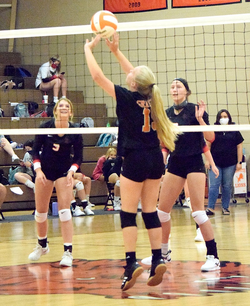 Westside Eagle Observer/MIKE ECKELS

Lady Lion Paige Greer (19) passes the ball back to a team mate setting up a spike into Lady Blackhawk territory during the Sept. 8 Gravette-Pea Ridge volleyball match at the competition gym in Gravette.