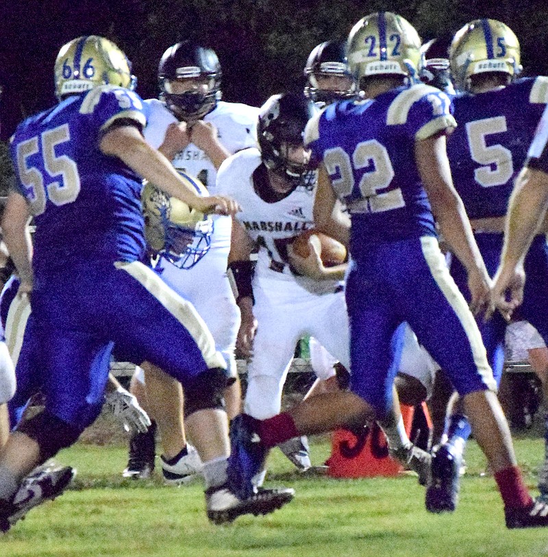 Westside Eagle Observer/MIKE ECKELS

Bobcat running back Colton Sutterfield (15) finds a pack of Bulldogs ready to take him down during the Friday night Decatur-Marshall eight-man football contest at Bulldogs Stadium in Decatur. A pair of touchdowns in the final two minutes of the game gave the Bobcats the win 54-40 over the Bulldogs.