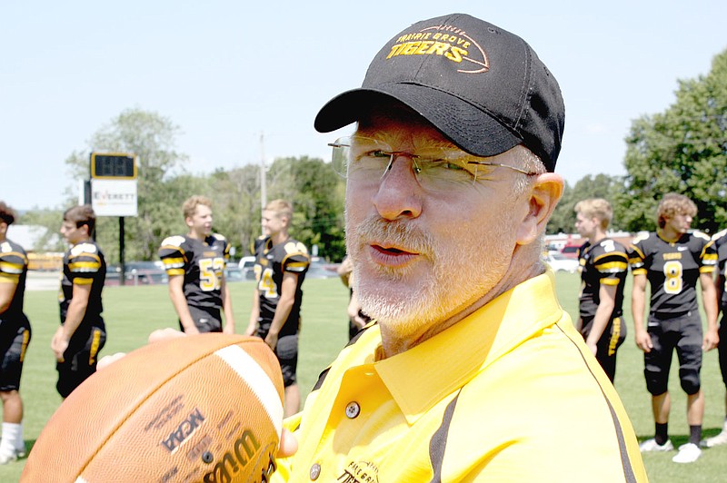 MARK HUMPHREY  ENTERPRISE-LEADER/Prairie Grove head football coach Danny Abshier affectionately grips a football, an tangible expression of his love for the game, during media day Aug. 4.