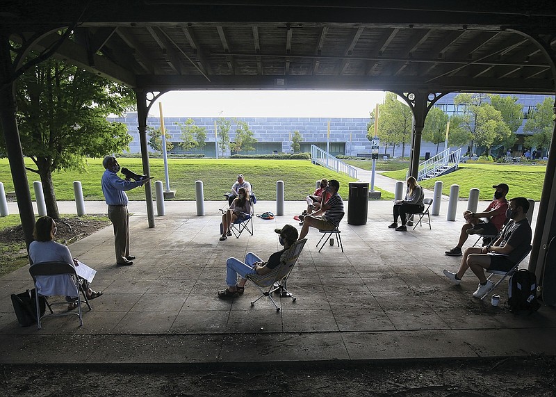 Skip Rutherford, Dean of the University of Arkansas Clinton School of Public Service, teaches his class Wednesday Sept. 9, 2020 in Little Rock in an are outside the school using a mega phone to be heard. (Arkansas Democrat-Gazette/Staton Breidenthal)