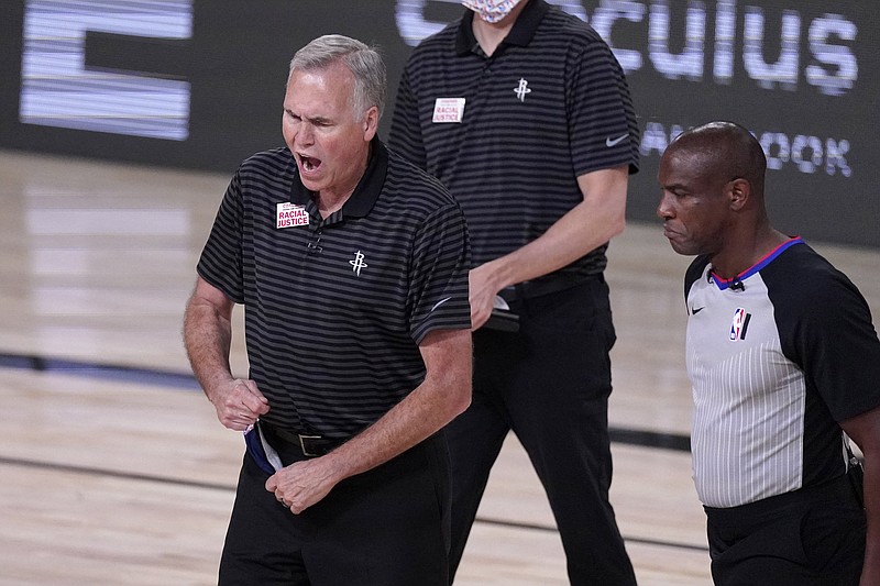 Houston Rockets coach Mike D'Antoni, left, yells at referee Tony Brown, right, during the second half of an NBA conference semifinal playoff basketball game against the Los Angeles Lakers Thursday, Sept. 10, 2020, in Lake Buena Vista, Fla. (AP Photo/Mark J. Terrill)