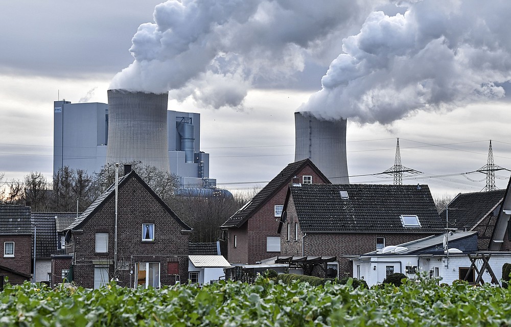 FILE - In this Monday, Jan. 13, 2020 file photo RWE lignite-fired power station releases steam in Bergheim, Germany. Streaming high-definition video and games can result in significant greenhouse gas emissions, depending on the technology used, according to a German government-backed study released Thursday. (AP Photo/Martin Meissner, file)