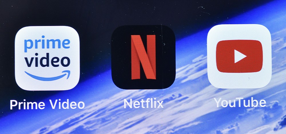 The apps of Amazon Prime Video, Netflix and YouTube are pictured on an iPhone in Gelsenkirchen, Germany, Thursday, Sept. 10, 2020. Streaming high-definition video and games can result in significant greenhouse gas emissions, depending on the technology used, according to a German government-backed study released Thursday. (AP Photo/Martin Meissner)