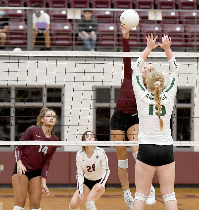 Bud Sullins/Special to Siloam Sunday
Siloam Springs volleyball seniors, from left, Makenna Thomas and Hanna Fullerton look on as senior teammate Clara Butler hits over Alma middle blocker Sidney Hatley during Thursday's 5A-West Conference match at Panther Activity Center. Alma defeated Siloam Springs 3-2.