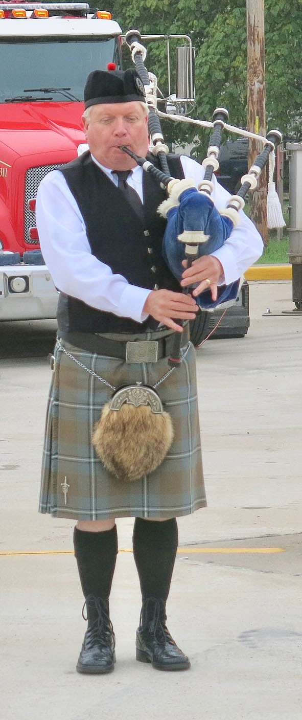 Westside Eagle Observer/SUSAN HOLLAND
David Ervin, a piper of Scottish heritage from Fayetteville, plays "Dawning of the Day" on the bagpipes to open the Sept. 11 remembrance ceremony at Gravette Friday morning. Several people attended the ceremony, hosted by the Gravette Fire Department, to honor those who lost their lives in the 2001 terrorist attacks.