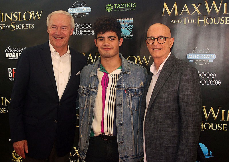 SkipStone Picture’s latest film, “Max Winslow and the House of Secrets,” filmed in Bentonville last year and is out now. The movie won Best Feature, Audience Choice Award and best Music Video for Emery Kelly’s “The Answers” at the Fayetteville Film Festival, among other festival awards. Gov. Hutchinson (from left), Kelly and producer and SkipStone CEO Johnny Remo attend the Northwest Arkansas red carpet event for the film.

(Courtesy Photo)