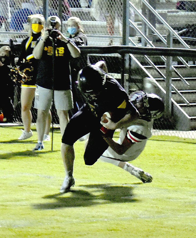 MARK HUMPHREY  ENTERPRISE-LEADER/Prairie Grove senior halfback Cade Grant broke a 34-yard touchdown run in the fourth quarter fighting off a tackle at the goal line to score. The Tigers snapped a 3-game losing streak in the rivalry by handing the Blackhawks a 35-33 nonconference loss Friday. Prairie Grove travels to Stilwell, Okla. this week. Kickoff is slated for 7 p.m. Friday.