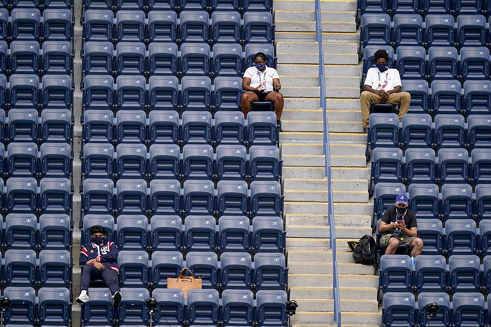 USTA event staff watch play during the women's singles final between Victoria Azarenka, of Belarus, and Naomi Osaka, of Japan, during the US Open tennis championships, Saturday, Sept. 12, 2020, in New York. (AP Photo/Frank Franklin II)