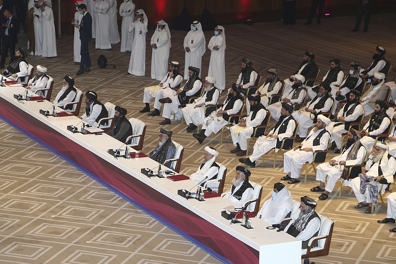 Taliban negotiator Abbas Stanikzai, fifth right, with his delegation attend the opening session of the peace talks between the Afghan government and the Taliban in Doha, Qatar, Saturday. - AP Photo/Hussein Sayed