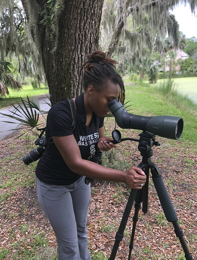 This 2020 photo provided by Deja Perkins shows her on Sapelo Island, Ga. Perkins, a conservation biologist at North Carolina State University, has studied gaps in how community-science bird-watching projects are conducted in wealthy and poor communities. “It's a problem if data from poor neighborhoods isn't collected, and that shapes wildlife management plans,” she said. - Jason Ward/Deja Perkins via AP