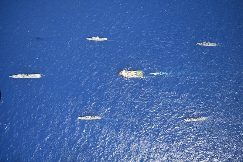 FILE - In this photo provided by the Turkish Defense Ministry on Aug 10, 2020, Turkey's research vessel, Oruc Reis, in red and white, is surrounded by Turkish navy vessels as it was heading in the west of Antalya on the Mediterranean, Turkey, Monday, . Greece says it will conduct a navy and air force exercise in an area of the eastern Mediterranean where Turkey is prospecting for oil and gas in an area as the neighboring countries remain locked in a dispute over offshore energy rights. (Turkish Defense Ministry via AP, Pool)