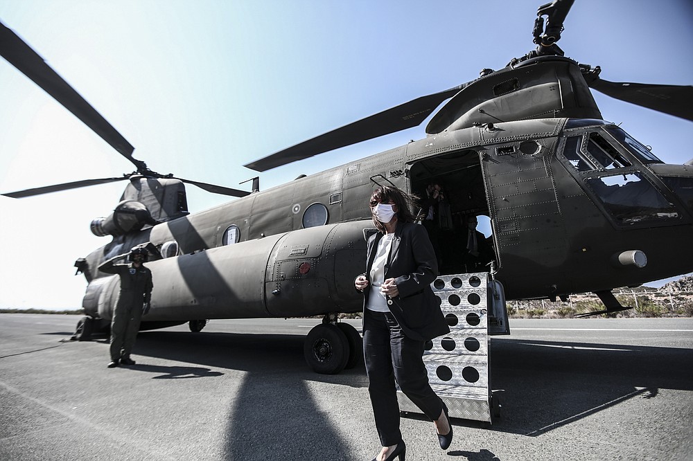 In this photo provided by the Greek President's office on Sunday, Sept. 13, 2020, Greece's President Katerina Sakellaropoulou arrives at Kastellorizo to attend the celebrations marking when the southeastern island of Kastellorizo, formally became part of Greece. Greece's prime minister outlined plans Saturday to upgrade the country's defense capabilities, including purchasing new fighter planes, frigates, helicopters and weapons systems amid heightened tensions with Turkey over rights to resources in the eastern Mediterranean. (Thodoris Manolopoulos/Greek President's Office via AP)