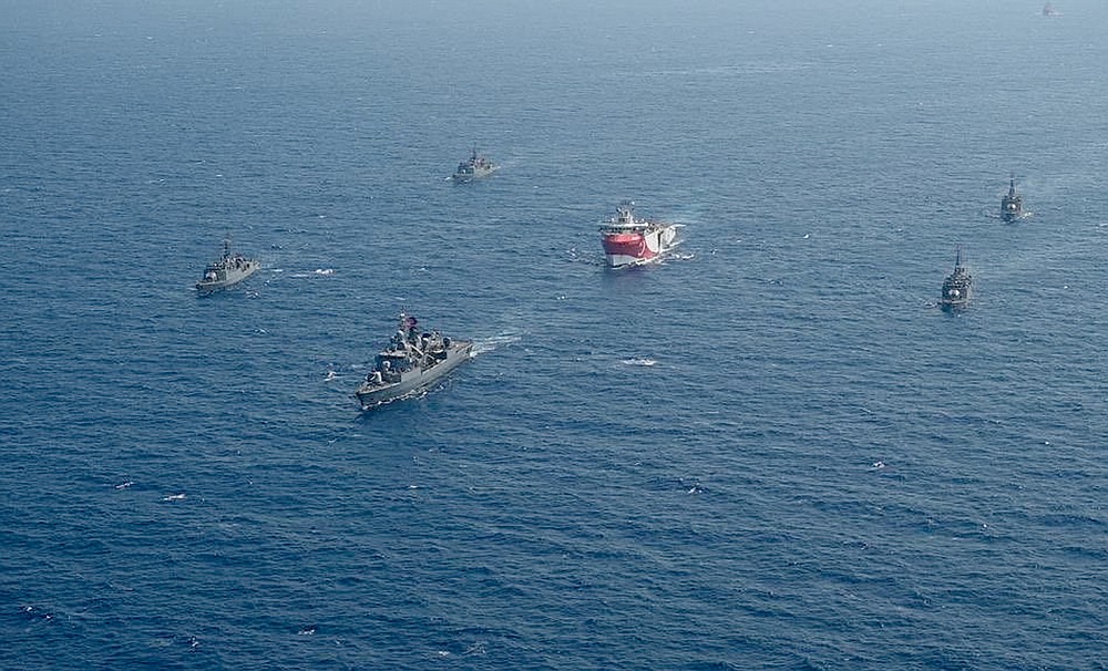 FILE - In this photo taken Monday, Aug. 10, 2020, Turkey's research vessel, Oruc Reis, center, is surrounded by Turkish navy vessels as it was heading in the west of Antalya on the Mediterranean, Turkey. Greece says it will conduct a navy and air force exercise in an area of the eastern Mediterranean where Turkey is prospecting for oil and gas in an area as the neighboring countries remain locked in a dispute over offshore energy rights. (IHA via AP)