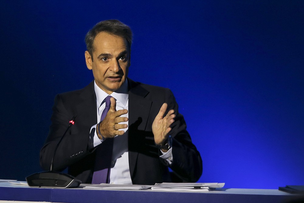 Greece's Prime Minister Kyriakos Mitsotakis addresses journalists during a news conference in the northern city of Thessaloniki, Greece, Sunday, Sept. 13, 2020. Mitsotakis outlined plans Saturday to upgrade the country's defense capabilities, including purchases of new fighter planes, frigates, helicopters and weapons systems, amid heightened tensions with neighboring Turkey over rights to resources in the eastern Mediterranean. (AP Photo/Giannis Papanikos)